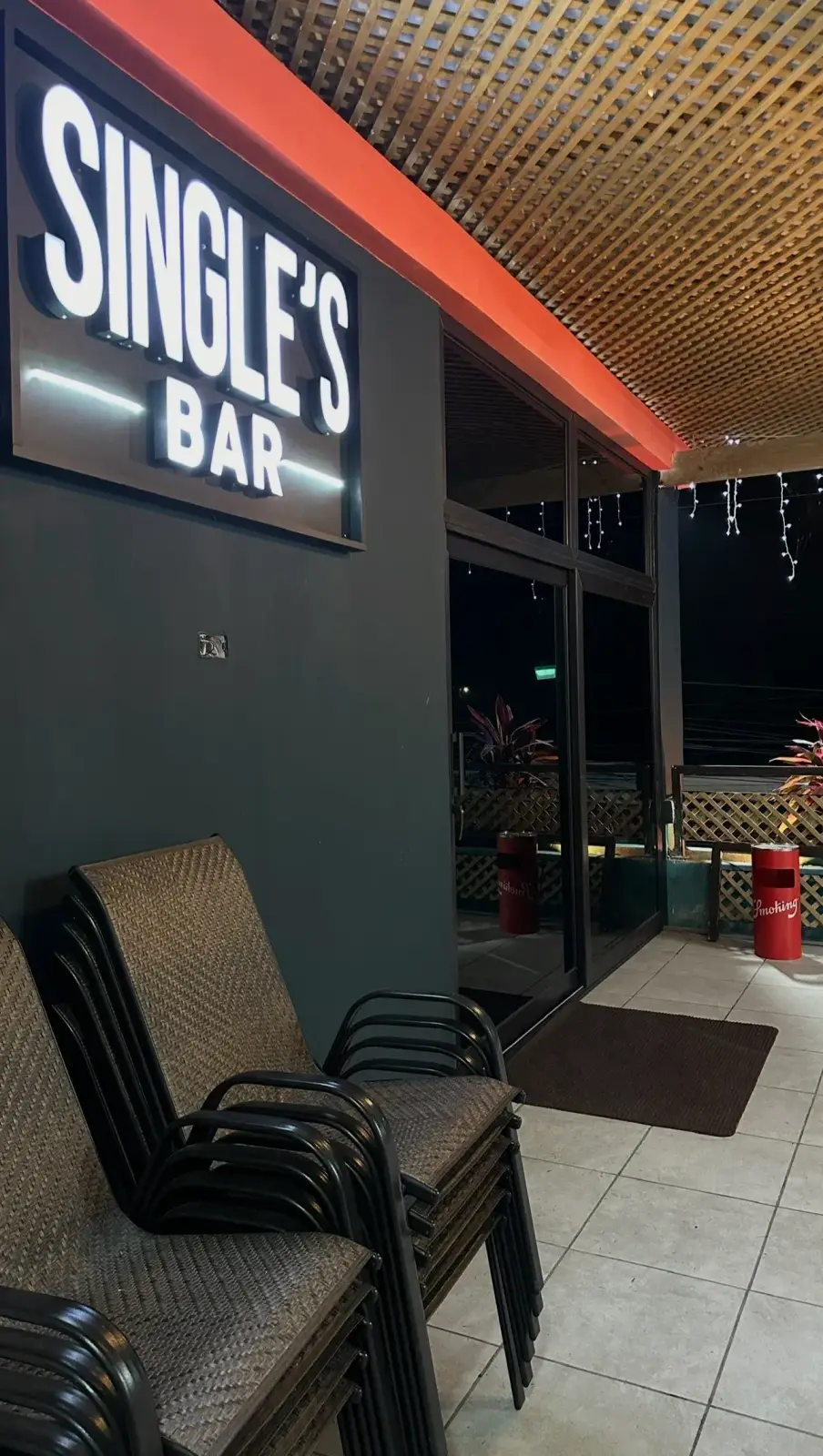 Real exterior of Single's Bar at night