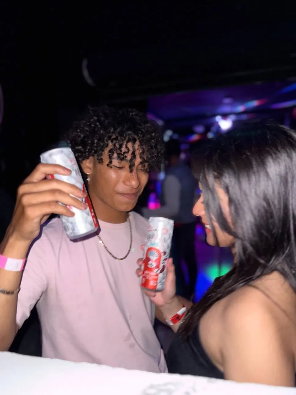Couple toasting with Barullo Mix on a real night at Single's Bar, Puerto Barrios